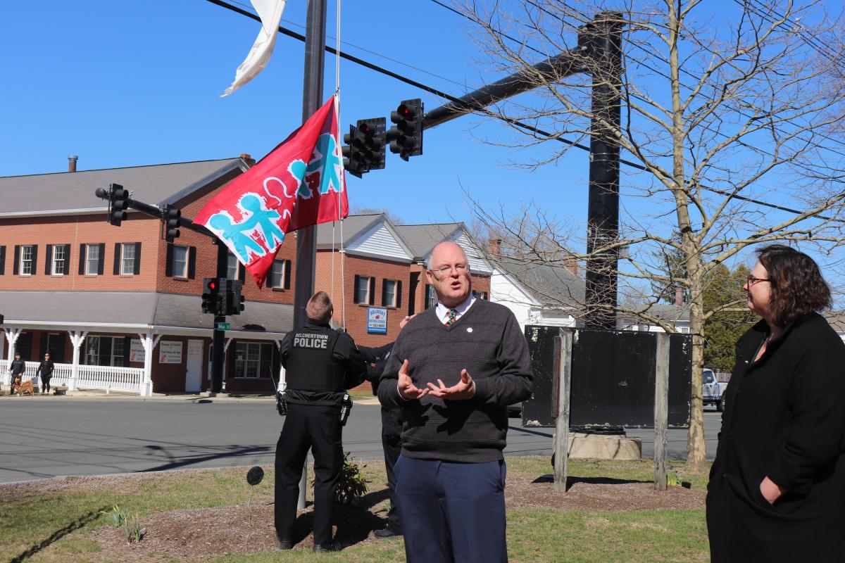 The Child Abuse Prevention flag is raised in Belchertown Monday.